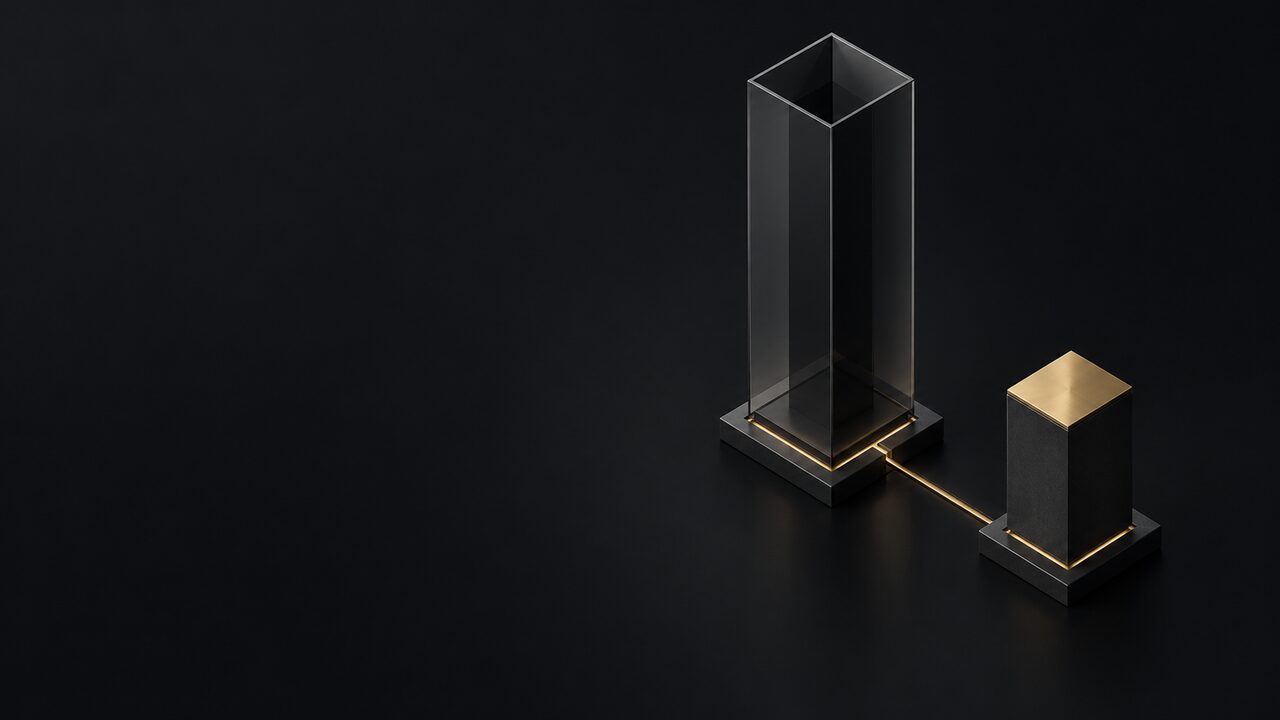 A tall empty glass column beside a short solid column with a brass top